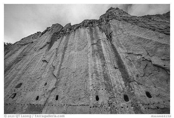 Cliff with bean holes and cavates. Bandelier National Monument, New Mexico, USA (black and white)