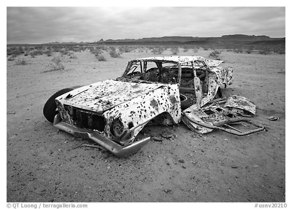 Car wreck used as a shooting target. USA (black and white)