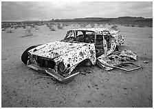 Car wreck used as a shooting target. Nevada, USA ( black and white)