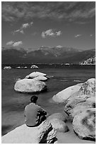 Man sitting on boulder, Sand Harbor, Lake Tahoe-Nevada State Park, Nevada. USA ( black and white)