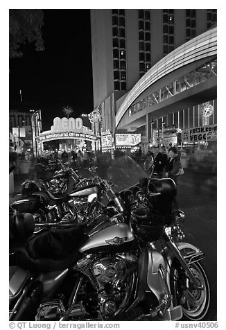 Harley-Davidson motorcycles on downtown street at night. Reno, Nevada, USA (black and white)