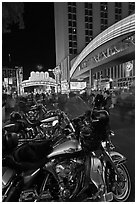 Harley-Davidson motorcycles on downtown street at night. Reno, Nevada, USA ( black and white)