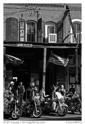 Motorcycles parked in front of brick historic building. Virginia City, Nevada, USA (black and white)
