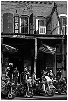 Motorcycles parked in front of brick historic building. Virginia City, Nevada, USA (black and white)