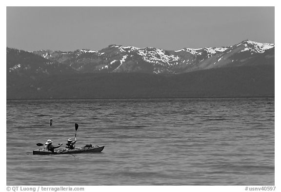 Kayak, turquoise waters and snowy mountains, East Shore, Lake Tahoe, Nevada. USA (black and white)
