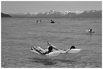 Children playing in water, and distant snowy mountains, Sand Harbor, Lake Tahoe, Nevada. USA (black and white)