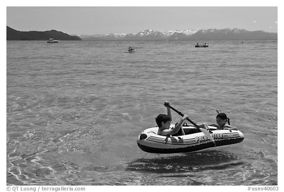 Children playing in inflatable boat, Sand Harbor, Lake Tahoe-Nevada State Park, Nevada. USA (black and white)