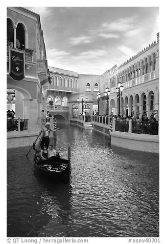 Gondolier singing song to couple during ride inside Venetian casino. Las Vegas, Nevada, USA (black and white)