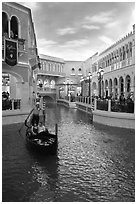 Gondolier singing song to couple during ride inside Venetian casino. Las Vegas, Nevada, USA ( black and white)