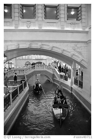 Couple kissing in gondola below bridge, Venetian casino. Las Vegas, Nevada, USA