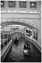 Couple kissing in gondola below bridge, Venetian casino. Las Vegas, Nevada, USA (black and white)