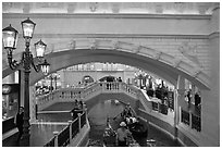 Gondolas passing below bridge, inside Venetian hotel. Las Vegas, Nevada, USA ( black and white)