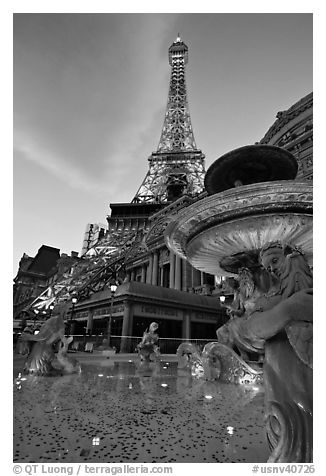 Fountain and Eiffel Tower replica at dusk, Paris casino. Las Vegas, Nevada, USA