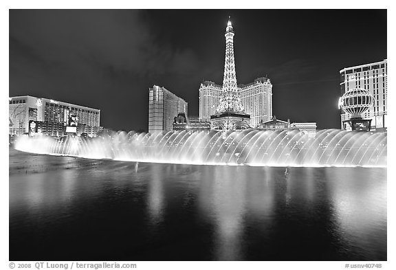 Bellagio dancing fountains and hotels reflected in lake. Las Vegas, Nevada, USA