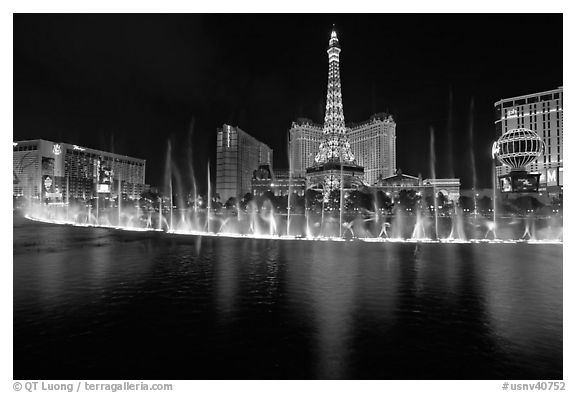 Bellagio dancing fountains and casinos reflected in lake. Las Vegas, Nevada, USA