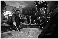 Dealer collecting during Craps game. Las Vegas, Nevada, USA (black and white)