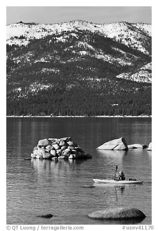 Kayaker with backdrop of snow-covered mountains, Lake Tahoe-Nevada State Park, Nevada. USA