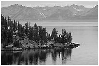 Lakeshore with houses and snow-covered mountains, Lake Tahoe, Nevada. USA (black and white)