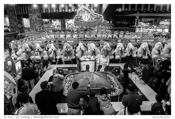 View from above of people playing carnival fishing game. Reno, Nevada, USA (black and white)