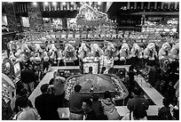 View from above of people playing carnival fishing game. Reno, Nevada, USA (black and white)