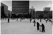 Skaters on holiday ice rink. Reno, Nevada, USA (black and white)