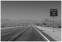 Highway and Next Gas 163 miles sign. Nevada, USA ( black and white)