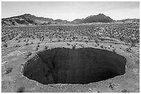 Aerial view of Devils Throat sinkhole. Gold Butte National Monument, Nevada, USA ( black and white)