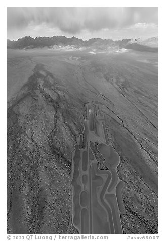 Aerial view of part of Michael Heizer's City leading to mountains. Basin And Range National Monument, Nevada, USA
