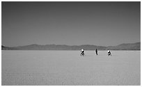 Three bicyclists on the desert Playa, Black Rock Desert. Nevada, USA ( black and white)
