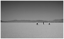 Three bicyclists on the desert Playa, Black Rock Desert. Nevada, USA ( black and white)