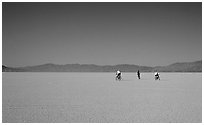 Three bicyclists on the desert Playa, Black Rock Desert. Nevada, USA (black and white)