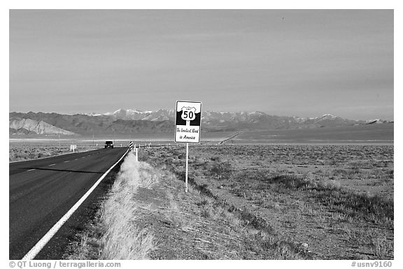 Sign reading Loneliest road in America. Nevada, USA (black and white)