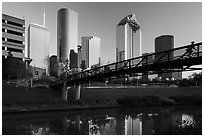 Bridge with bicyclist, reflection, and skyline. Houston, Texas, USA ( black and white)