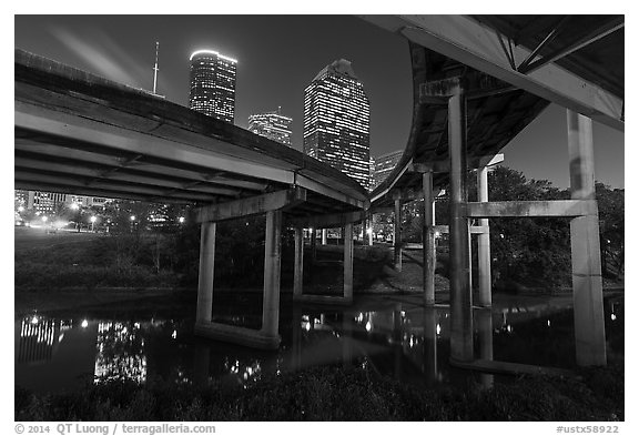 Skyline from under highway bridges at night. Houston, Texas, USA (black and white)