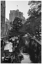 Riverwalk promenade, approaching barge. San Antonio, Texas, USA ( black and white)