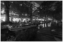 Barge and walkway at dusk, Riverwalk. San Antonio, Texas, USA ( black and white)