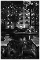 Waterfall, elegant couple in distance. San Antonio, Texas, USA ( black and white)