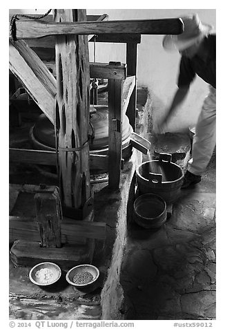 Man operating mill, Mission San Jose. San Antonio, Texas, USA (black and white)