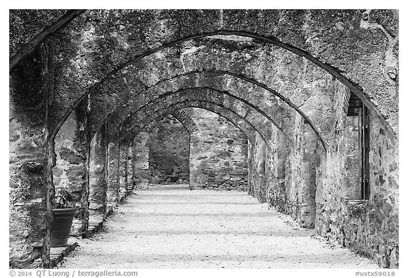 Arched walkway leading to the church, Mission San Jose. San Antonio, Texas, USA (black and white)