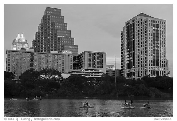 Water pedaling in front of skyline at dusk. Austin, Texas, USA (black and white)