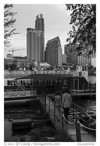 Walking into tour boat on Colorado River. Austin, Texas, USA (black and white)