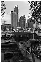 Walking into tour boat on Colorado River. Austin, Texas, USA ( black and white)