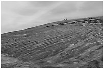 Granite dome with hikers, Enchanted Rock. Texas, USA ( black and white)