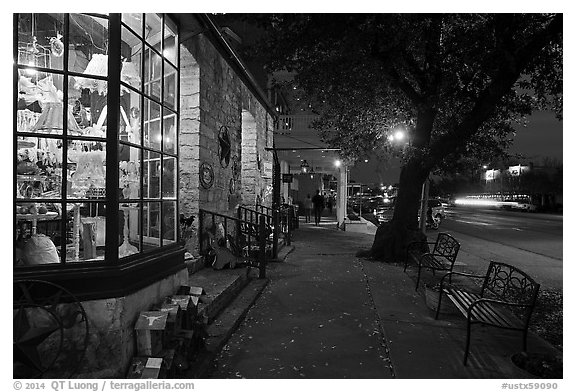 Sidewalk and stores at dusk. Fredericksburg, Texas, USA (black and white)