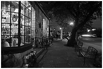 Sidewalk and stores at dusk. Fredericksburg, Texas, USA ( black and white)