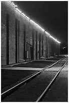 Railroad tracks and brick buildings at night, Stockyards. Fort Worth, Texas, USA ( black and white)