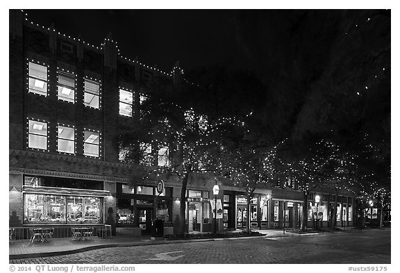 Street at night with lighted stores. Fort Worth, Texas, USA (black and white)