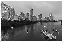 Skyline and tour boats on Colorado River at dusk. Austin, Texas, USA ( black and white)