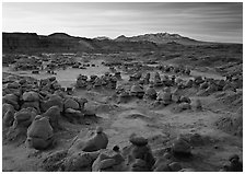 Goblins and snowy mountains at sunrise, Goblin State Park. Utah, USA ( black and white)