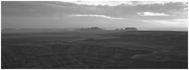 Sunset over canyon and distant mesas. Monument Valley Tribal Park, Navajo Nation, Arizona and Utah, USA (Panoramic black and white)